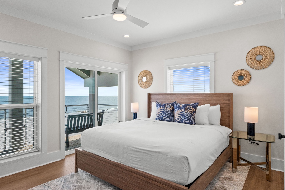 Wake up to sweeping ocean views from your private balcony. This coastal bedroom features a king bed, stylish coastal decor, and direct access to breathtaking sea vistas.