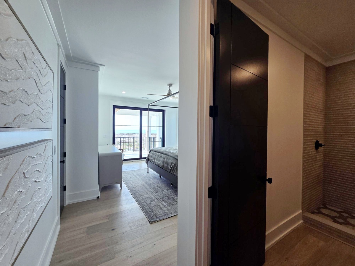 Step into your stylish bedroom retreat with modern design touches and ocean views through the balcony doors.