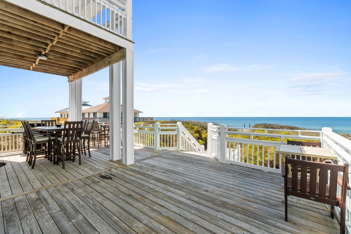Relax on your private deck with ocean views, outdoor dining space, and coastal breezes just steps from the beach.