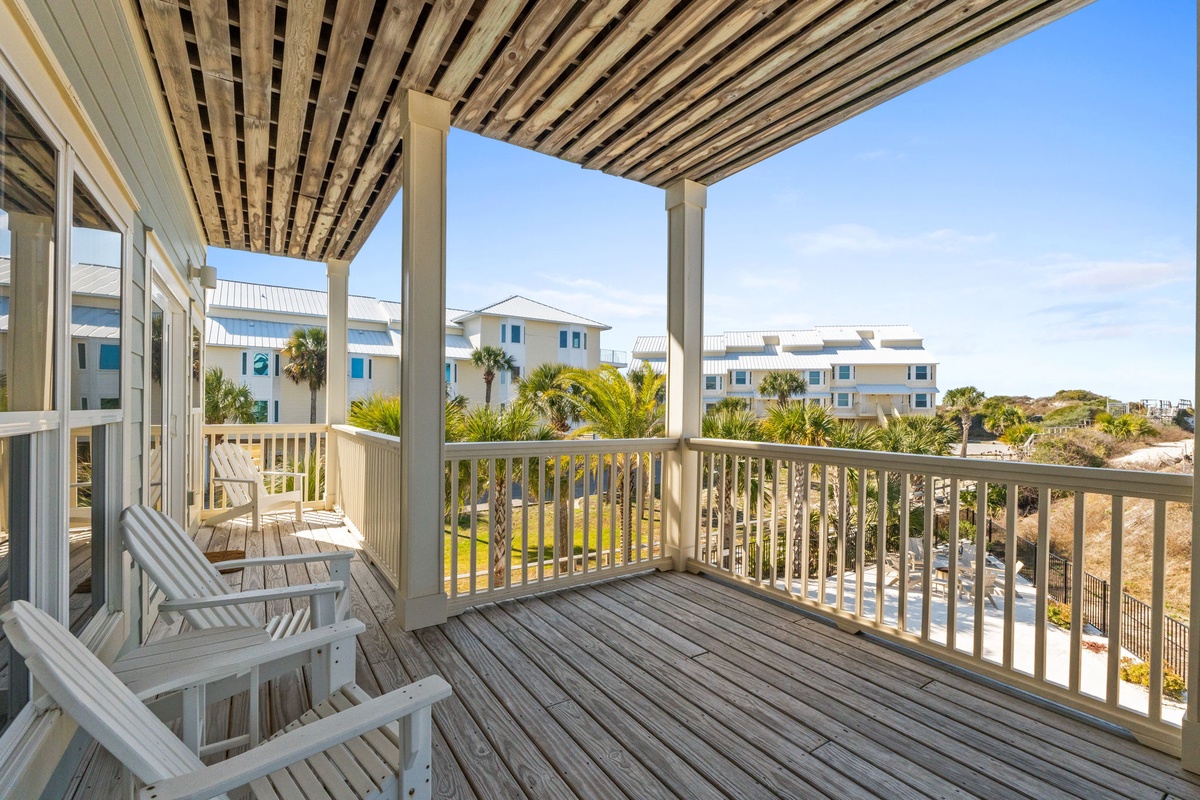 Relax in comfortable seating on your private covered balcony, overlooking tropical palms and coastal scenery.