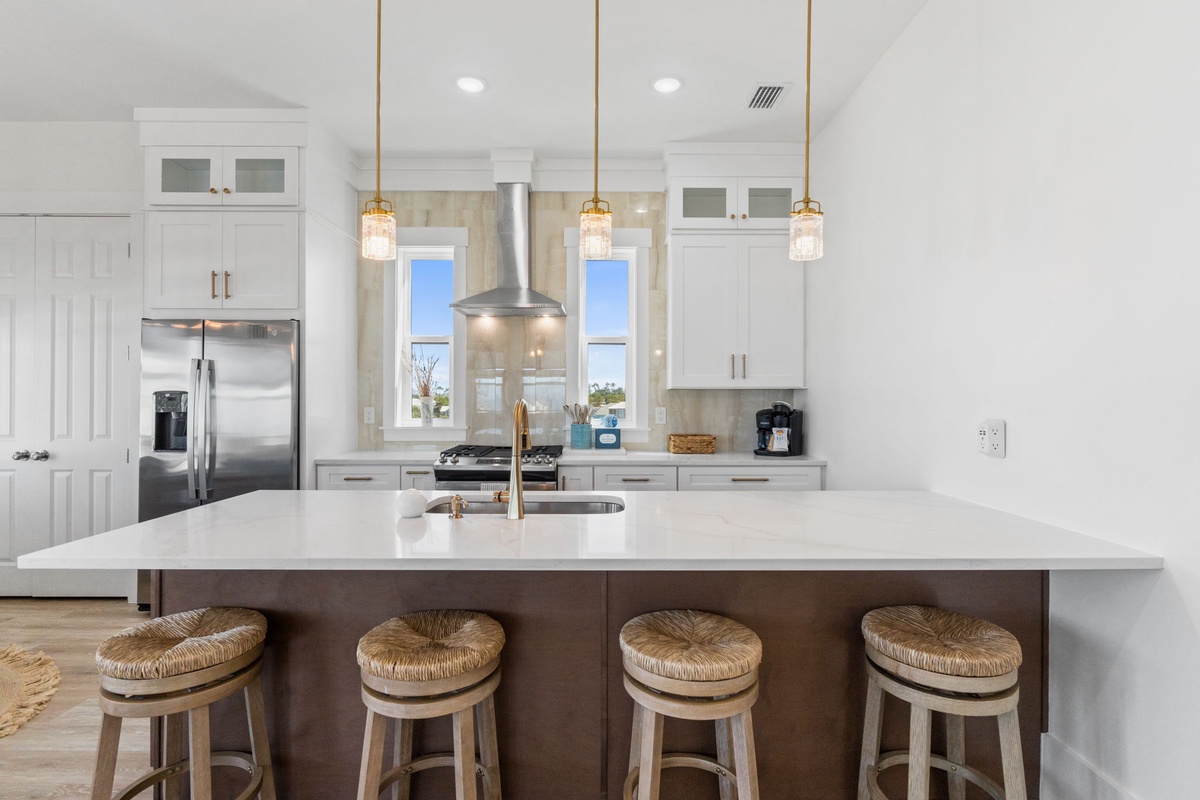 Cook like a chef in this stunning modern kitchen featuring pristine white cabinetry, gleaming countertops, and a spacious island perfect for your culinary adventures.