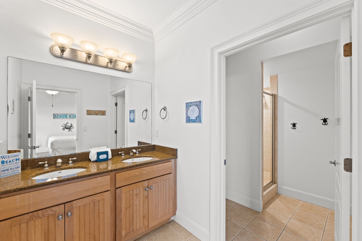 Step into your private spa-like retreat with a spacious double vanity, gleaming granite countertops, and plenty of room for your morning routine.