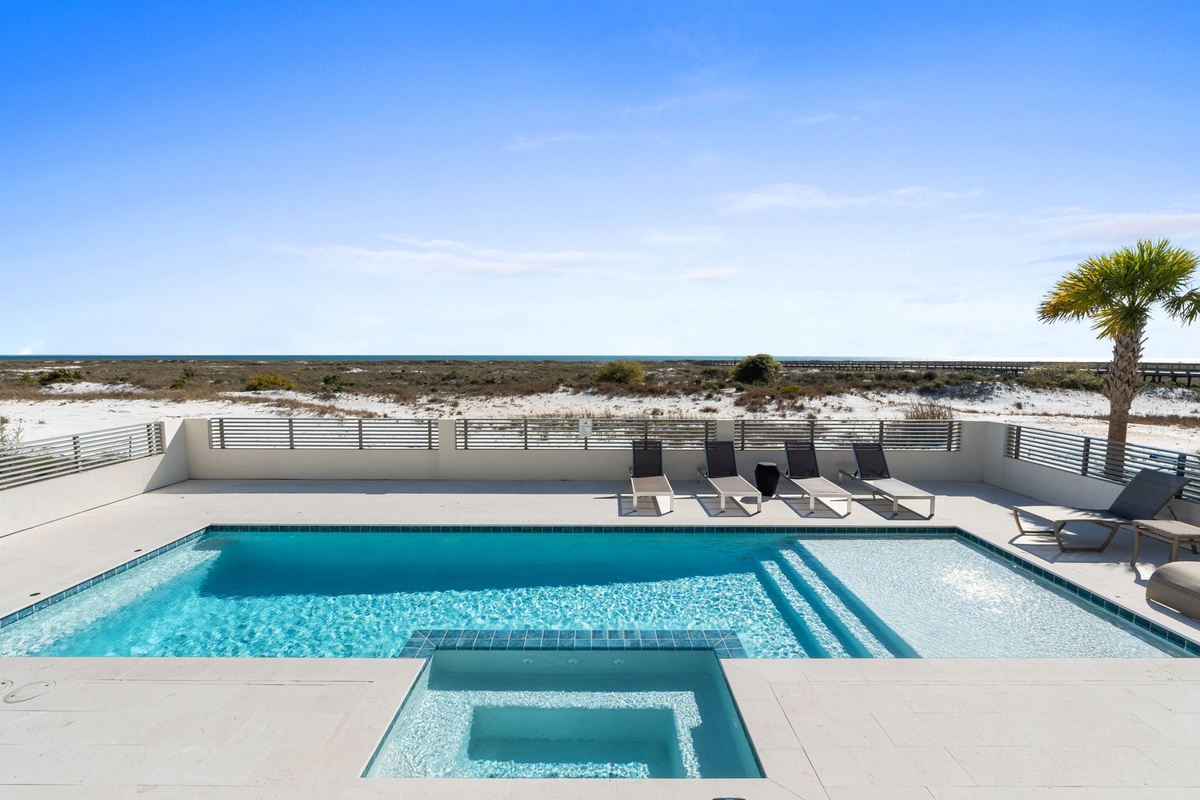 Stunning beachfront pool and hot tub with panoramic ocean views and pristine white sand dunes.