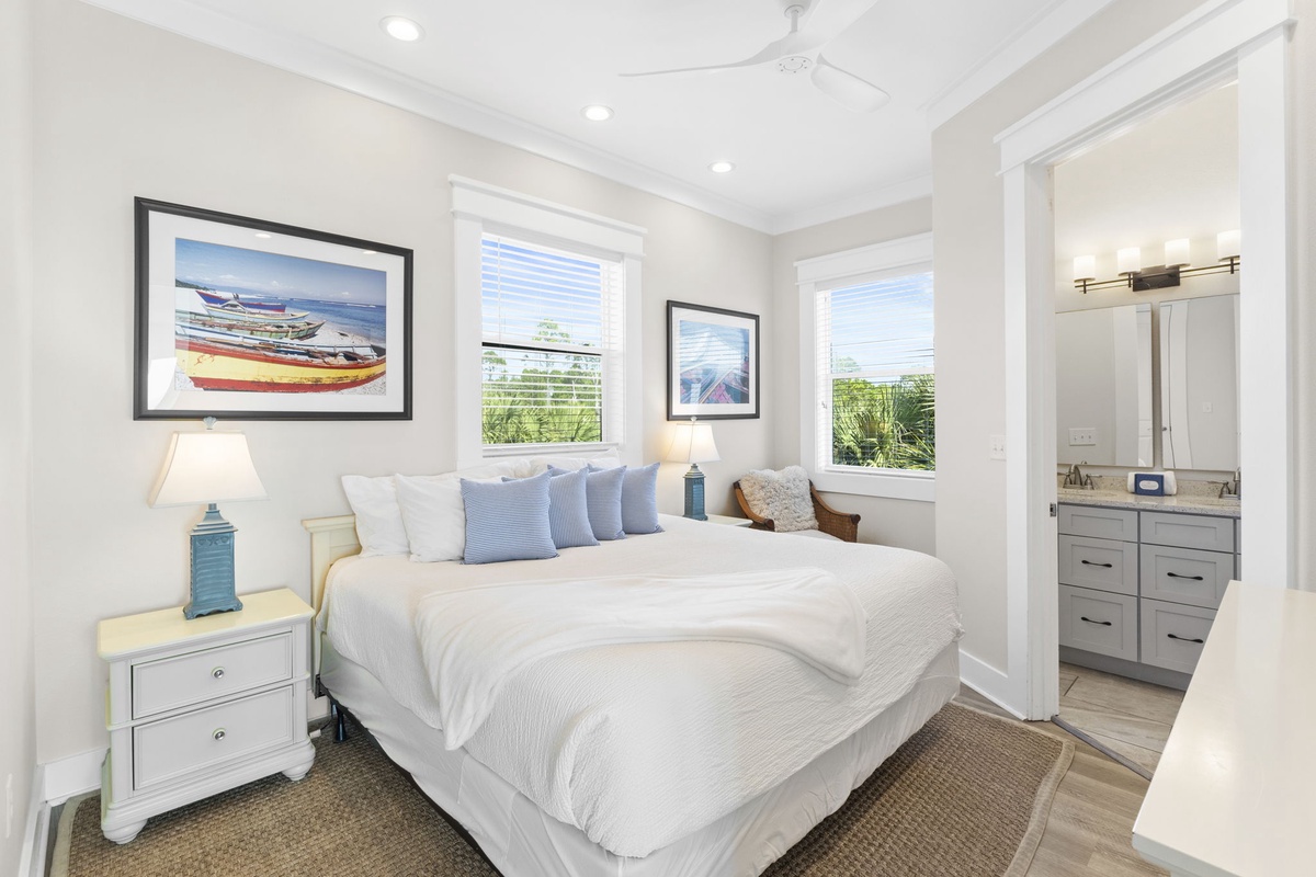 Drift off to sleep in this serene bedroom where coastal artwork and soft linens create your peaceful retreat.