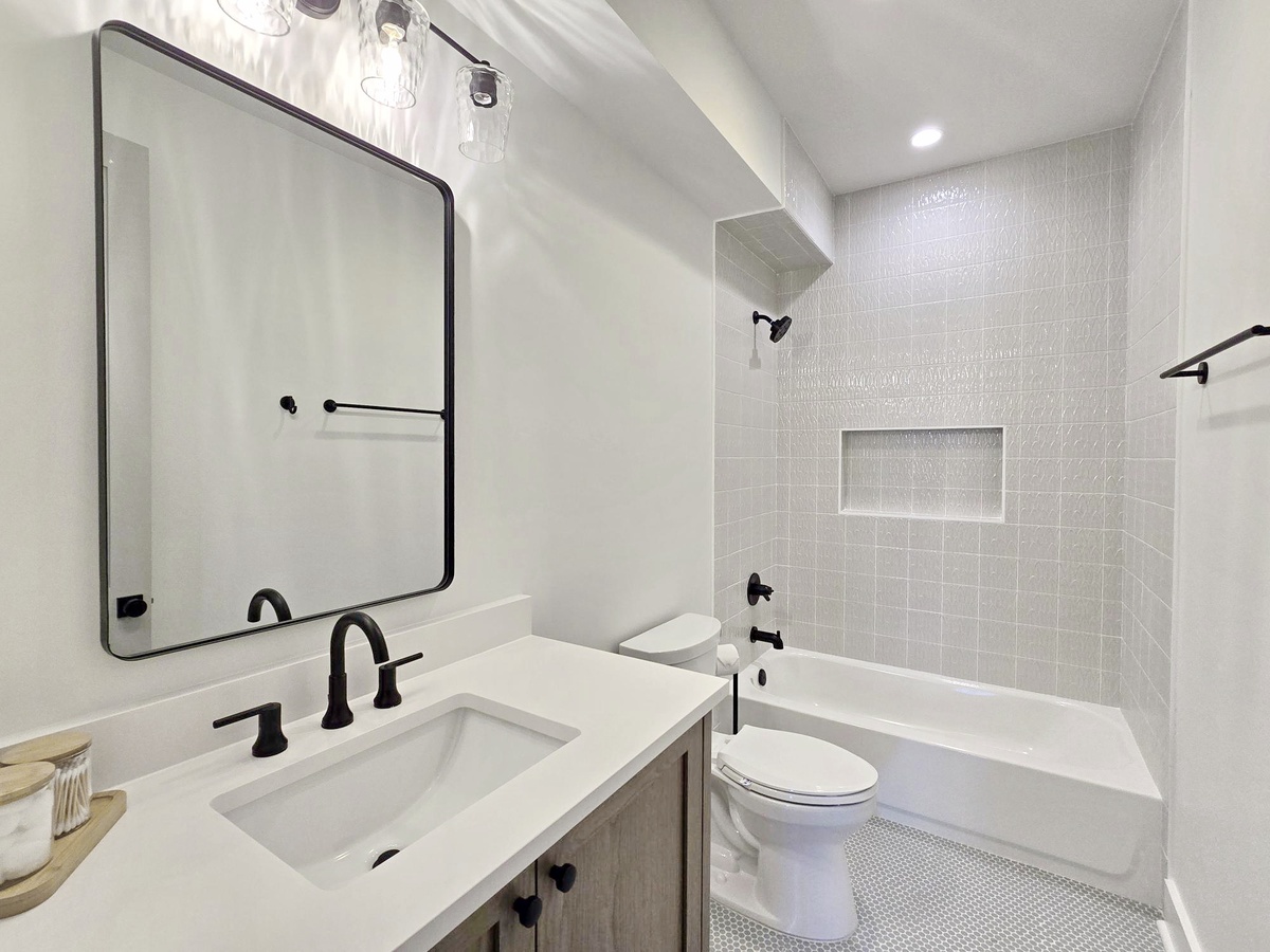 Unwind in your modern bathroom featuring a luxurious soaking tub, sleek fixtures, and elegant tile work for ultimate relaxation.