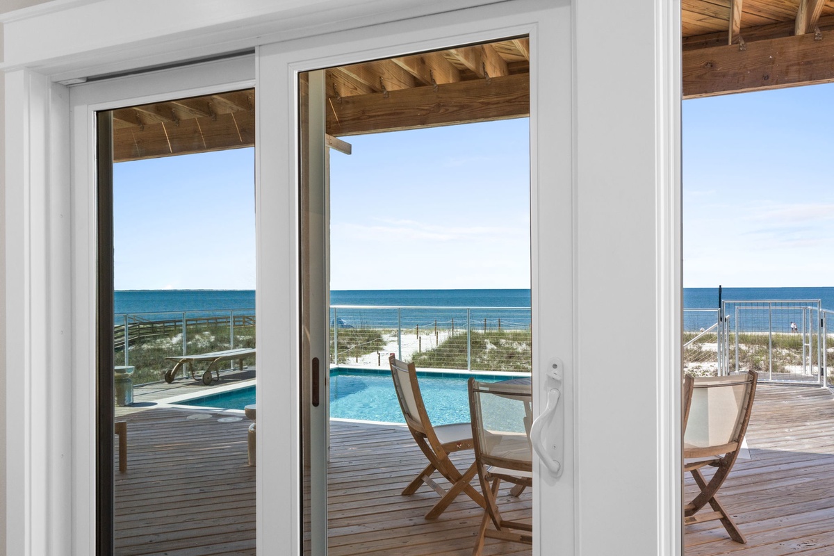 Step through these doors onto your private deck, where sparkling pool waters meet endless ocean views and soft sand beaches just beyond.