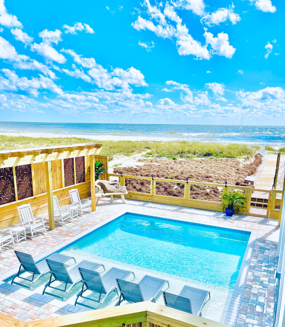 Your private pool deck overlooks pristine ocean waves, where crystal-clear waters meet endless blue skies for pure coastal bliss.