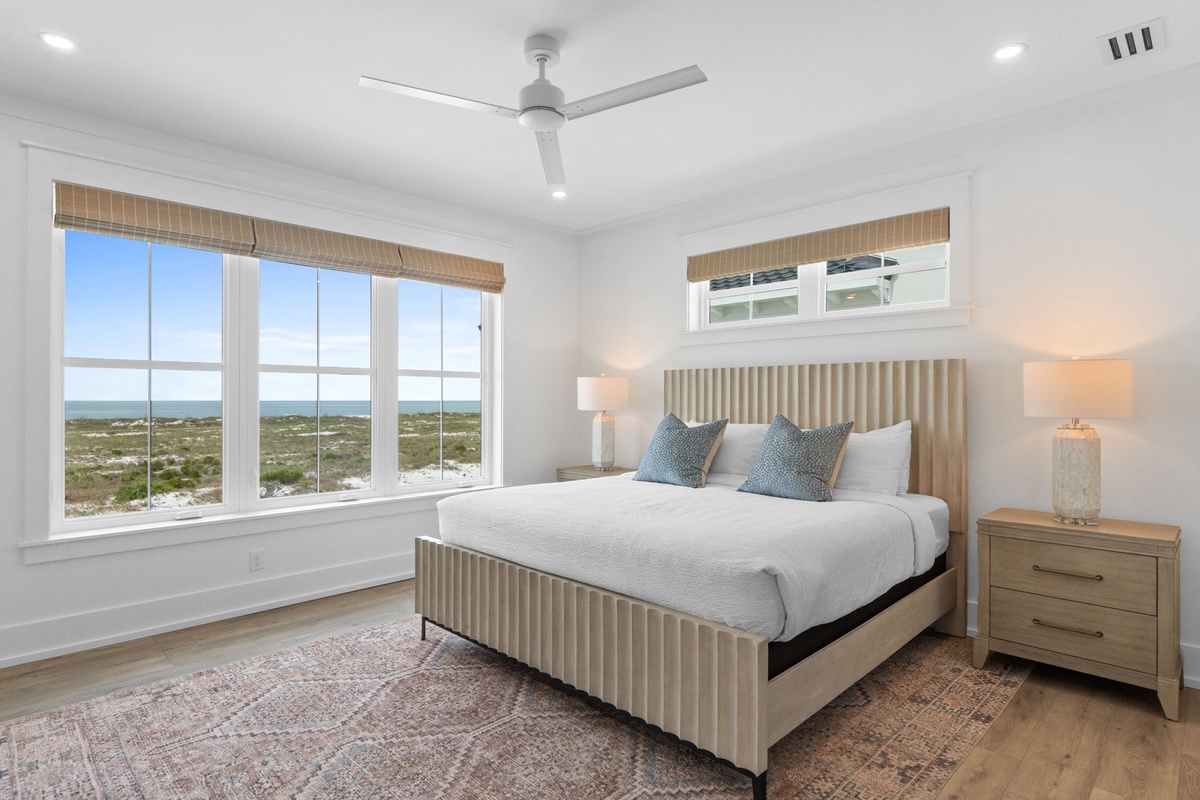Wake to sweeping coastal views from this serene bedroom, where soft linens and gentle ocean breezes create your perfect seaside retreat.