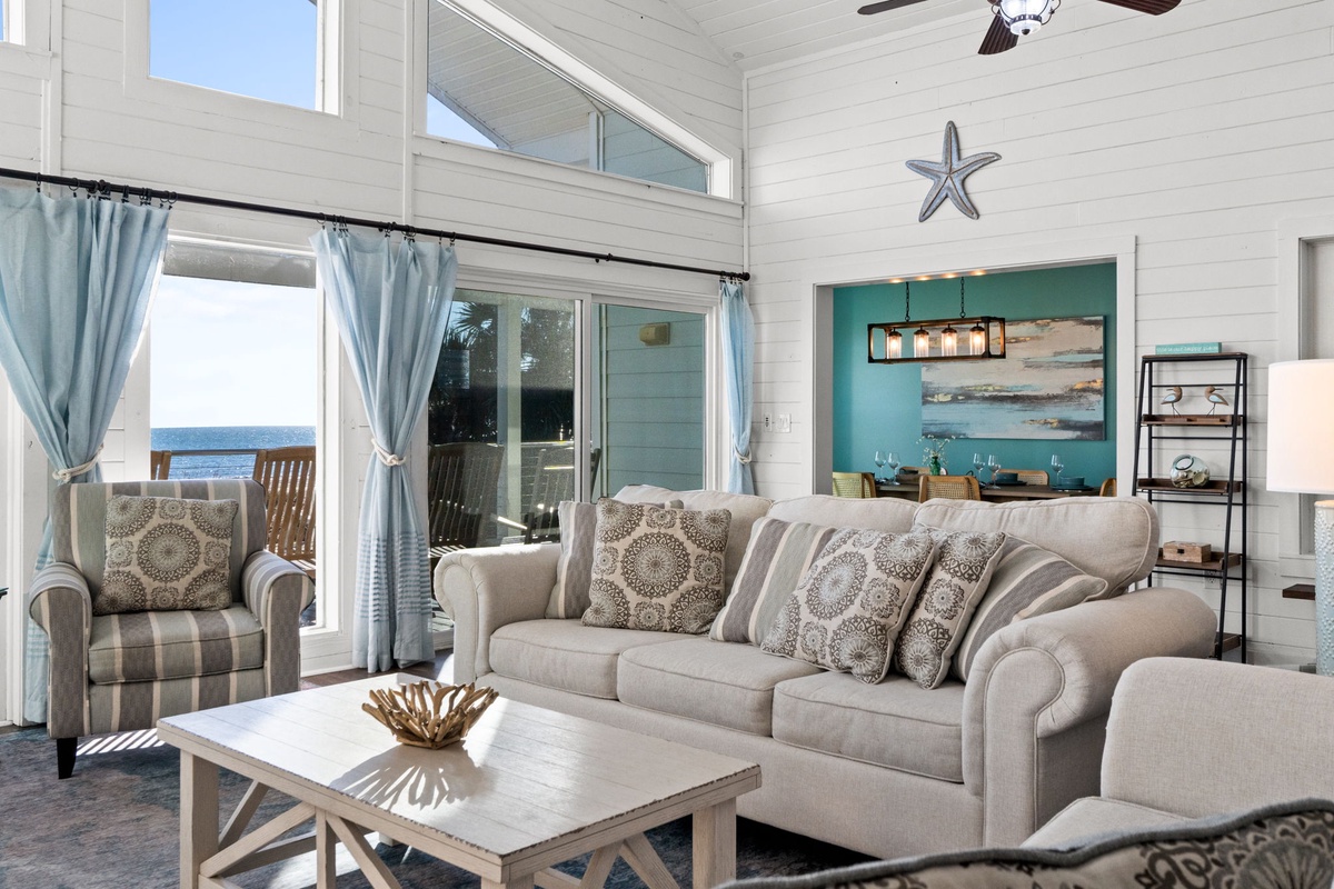 Relax in your coastal living room where soft sea breezes flow through open doors and ocean views create the perfect backdrop for your getaway.