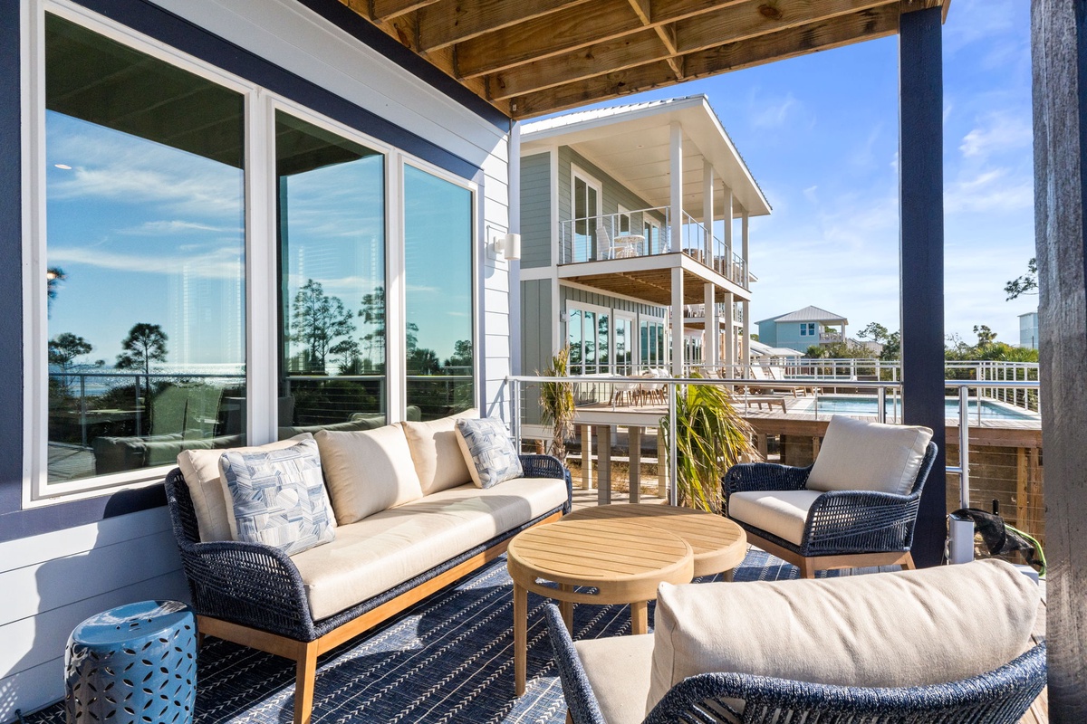 Relax in your private covered patio with plush seating and stunning water views reflected in floor-to-ceiling windows.