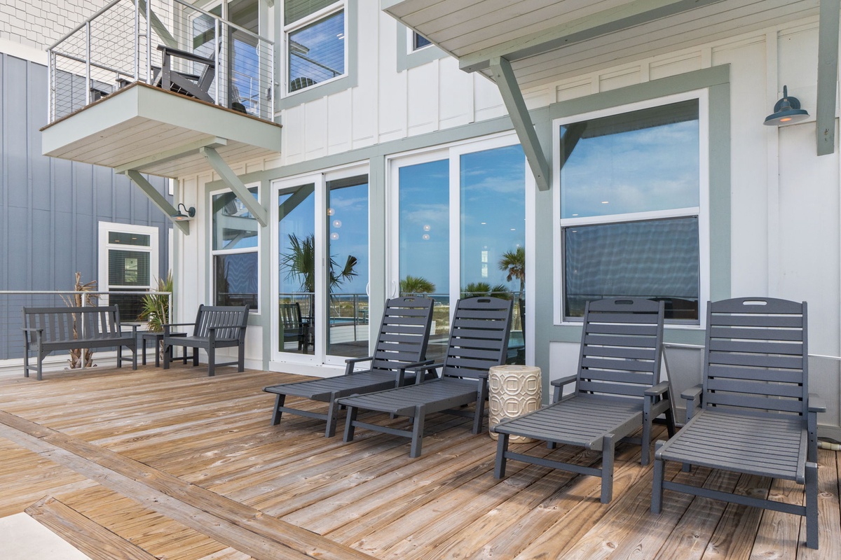 Stretch out on your private deck, where lounge chairs catch the sun and ocean breezes drift through palm trees. Floor-to-ceiling windows frame your coastal escape.