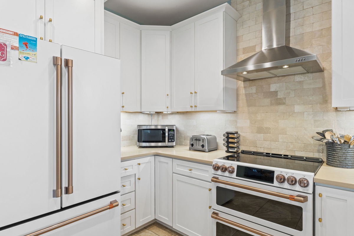 Cook your favorite meals in this well-equipped kitchen featuring modern stainless steel appliances, a gas range, and all the cookware you need for a home-away-from-home experience.