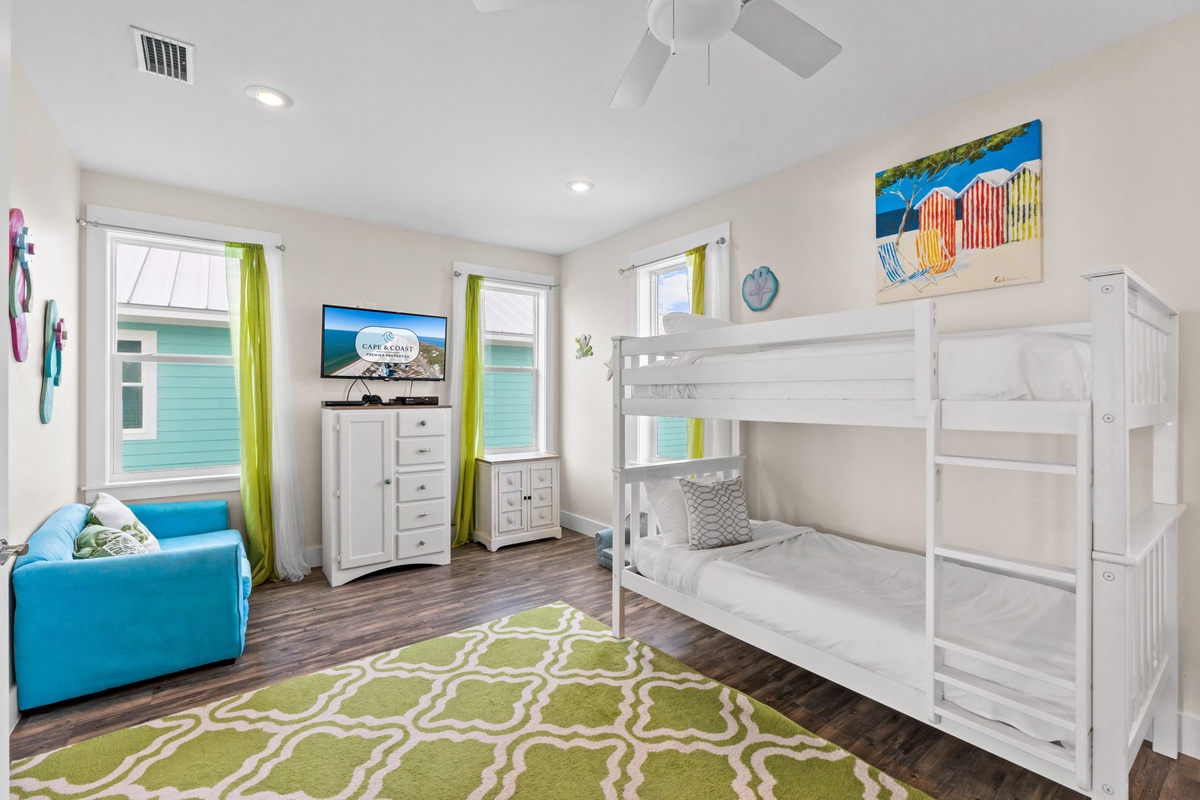 Your kids will love this bright, beach-themed bedroom with cozy bunk beds and entertainment center for family movie nights.
