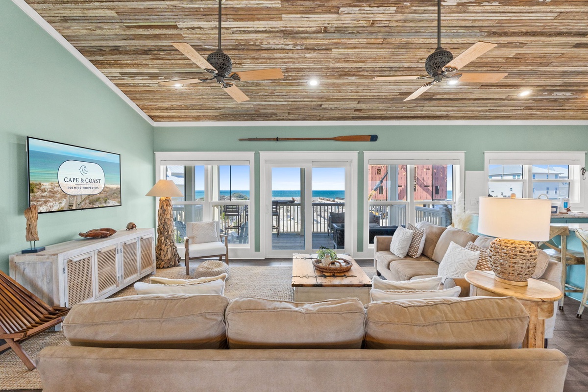 Unwind in this spacious living room where natural textures meet coastal comfort. You'll love the ocean views through floor-to-ceiling windows.