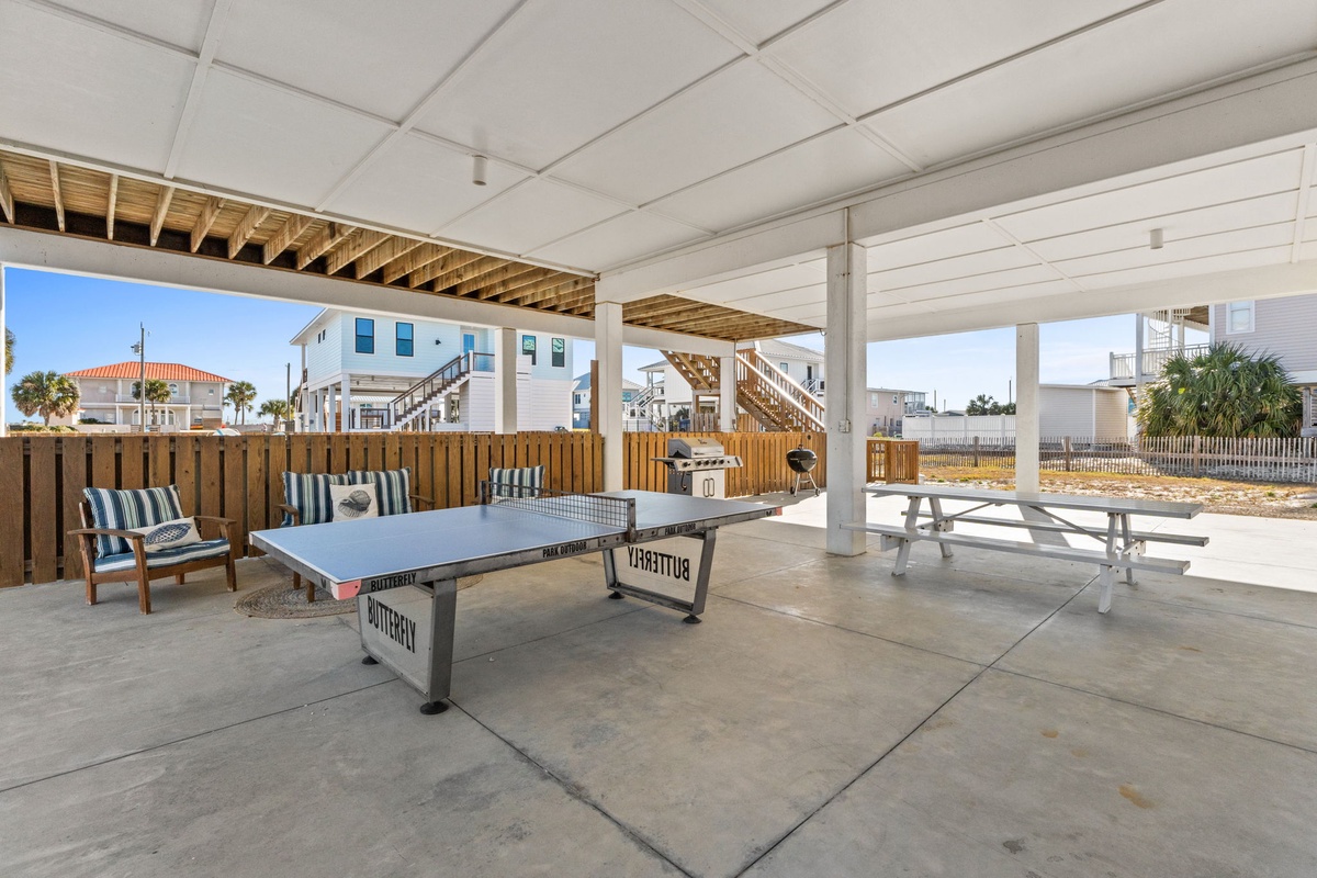 Challenge friends to ping pong matches in your covered outdoor game area, complete with seating and picnic tables for post-game snacks.