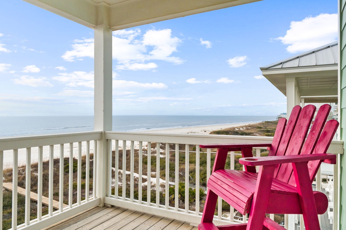 Relax in your vibrant pink Adirondack chairs while taking in breathtaking ocean views from your private balcony.