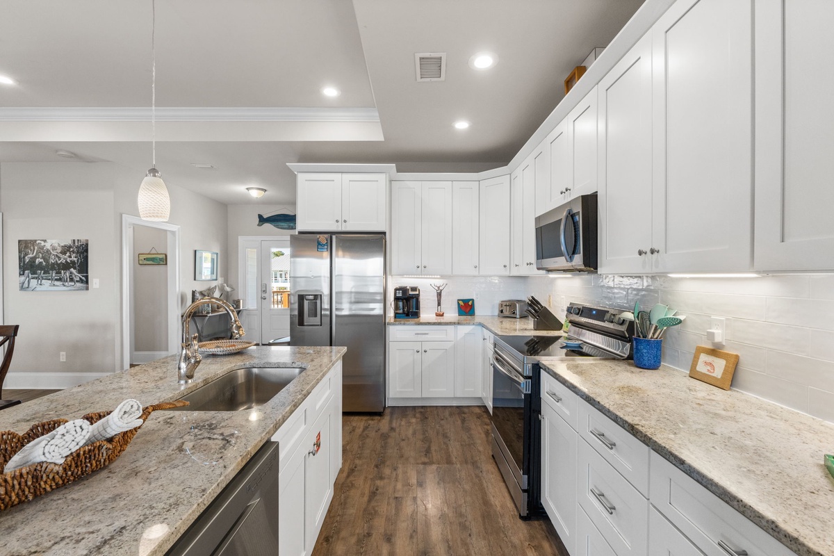 Prepare your favorite meals in this bright, modern kitchen with granite counters, stainless appliances, and plenty of workspace.