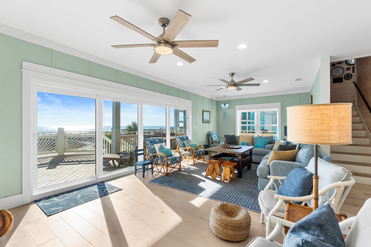 Relax in your bright coastal living room with stunning ocean views and cooling ceiling fans throughout.