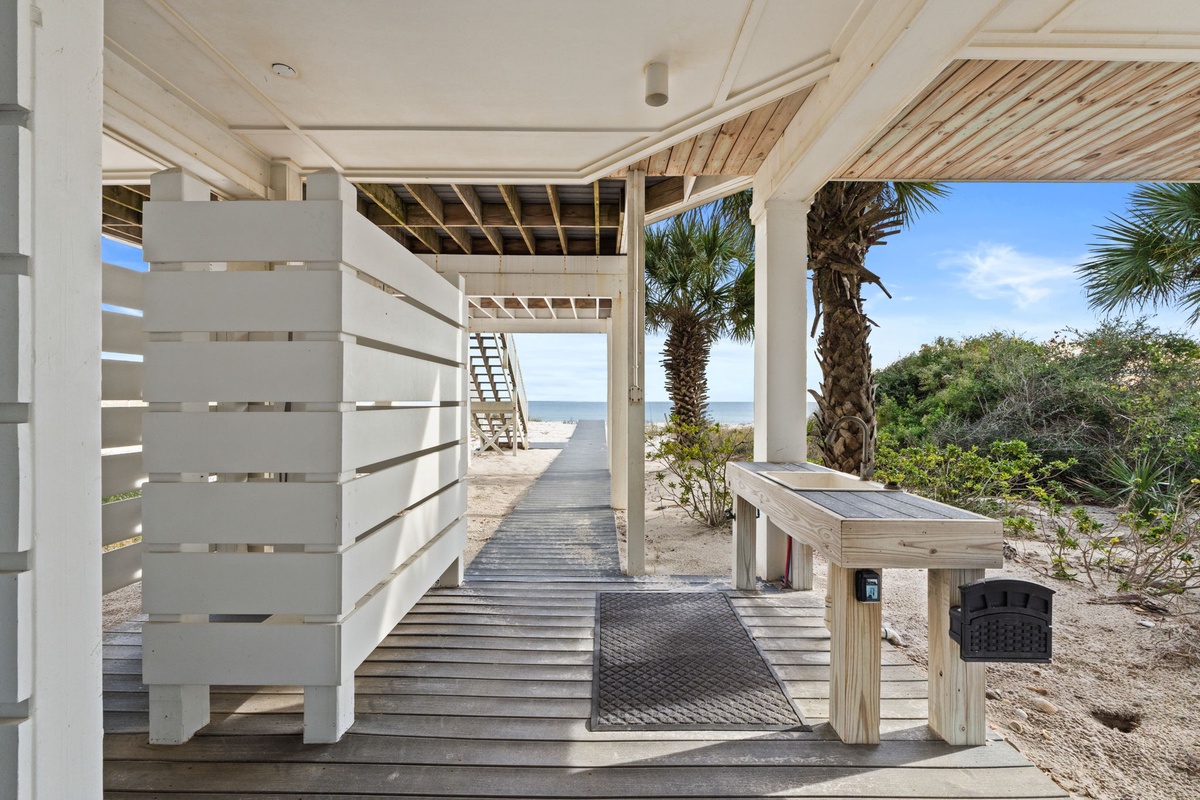 Step onto your private covered deck where tropical palms frame stunning ocean views and coastal breezes welcome you to paradise.