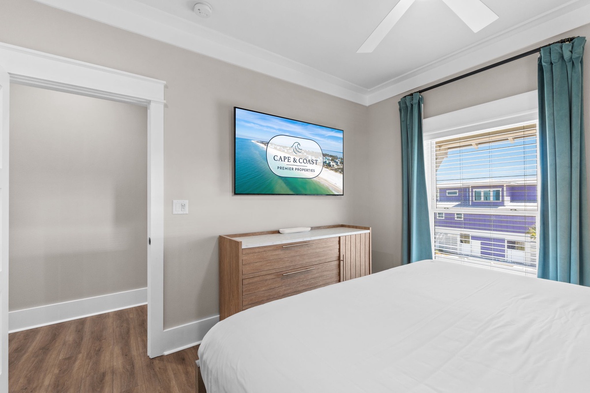 Unwind in your serene bedroom, with plush linens, calming coastal accents, and neighborhood views framing your getaway.