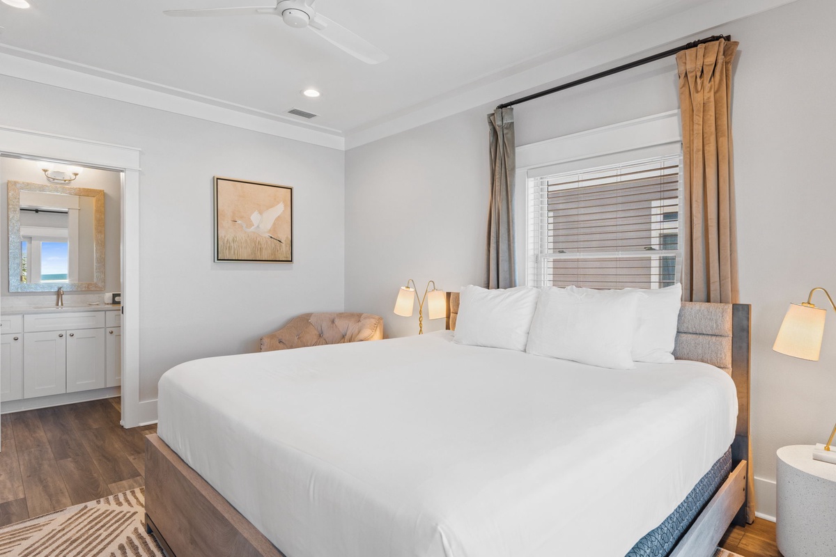 Sink into crisp white linens and unwind in your serene coastal bedroom, where soft lighting and calming neutral tones create the perfect retreat after a day of exploration.
