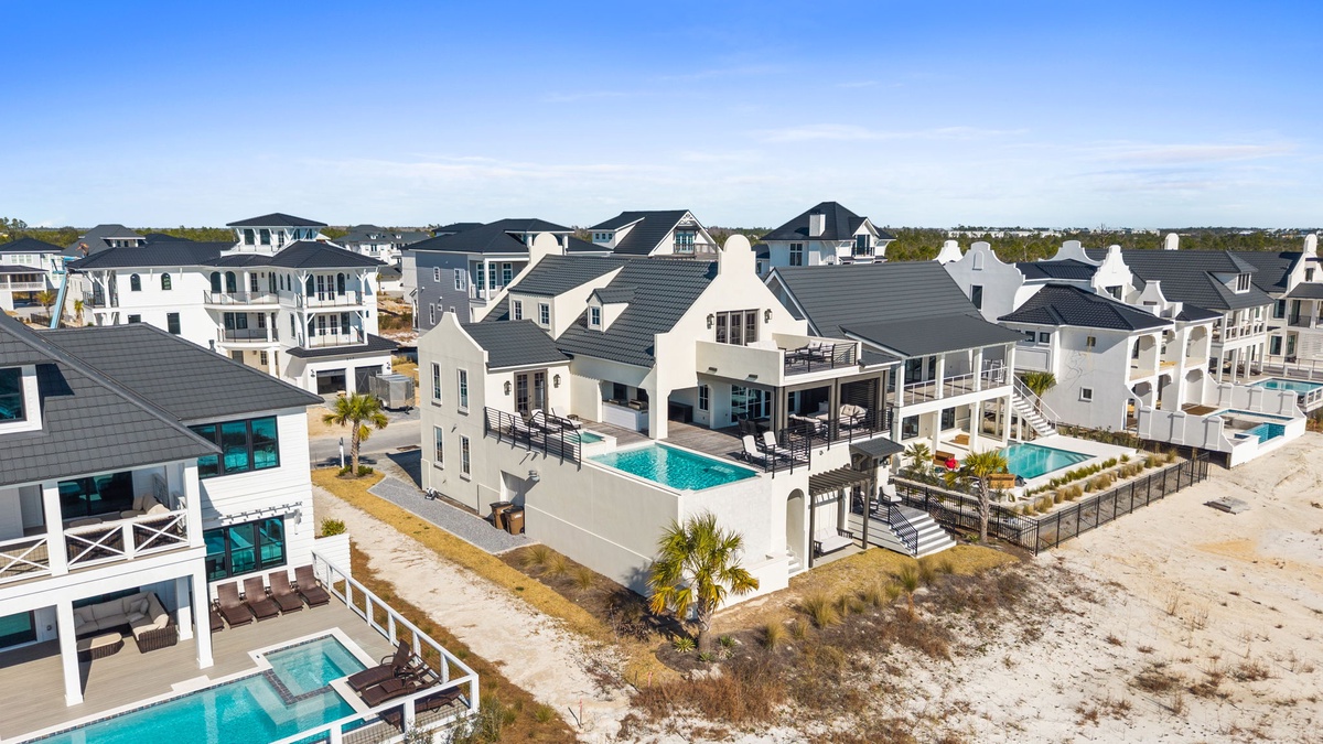 Stunning beachfront community with luxury homes featuring private pools and pristine white sand access just steps away.