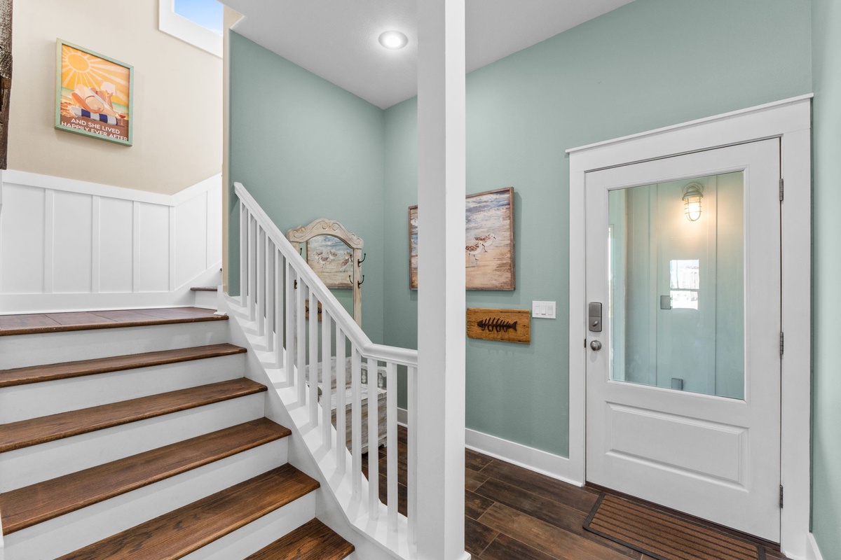 Step into your welcoming coastal retreat through beautiful hardwood floors and soothing mint walls that instantly make you feel at home.