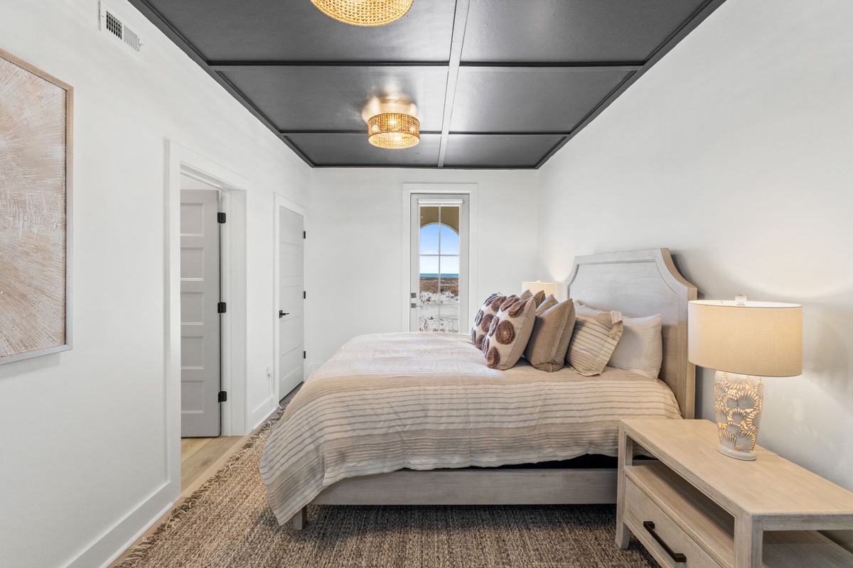 Drift off to sleep in your elegant bedroom with plush linens, warm lighting, and stunning views beyond your window.