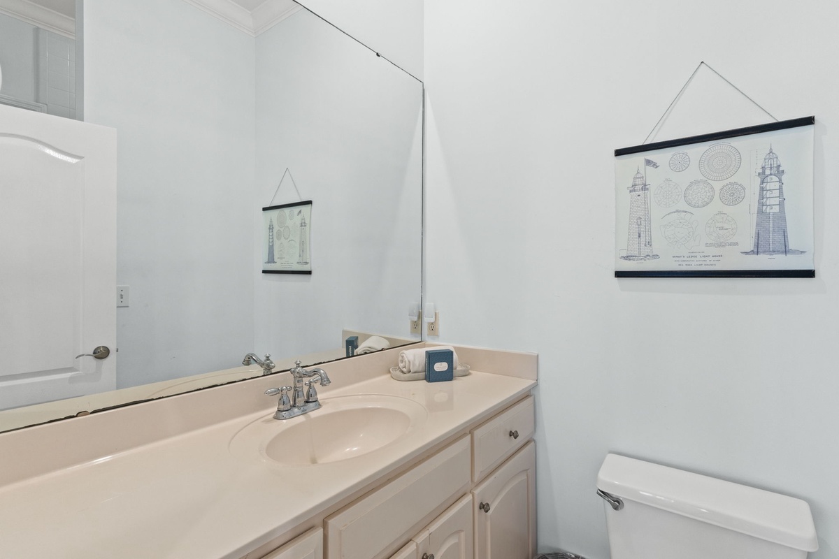 Your private bathroom features a spacious vanity and thoughtful coastal-themed touches that create a serene morning routine.