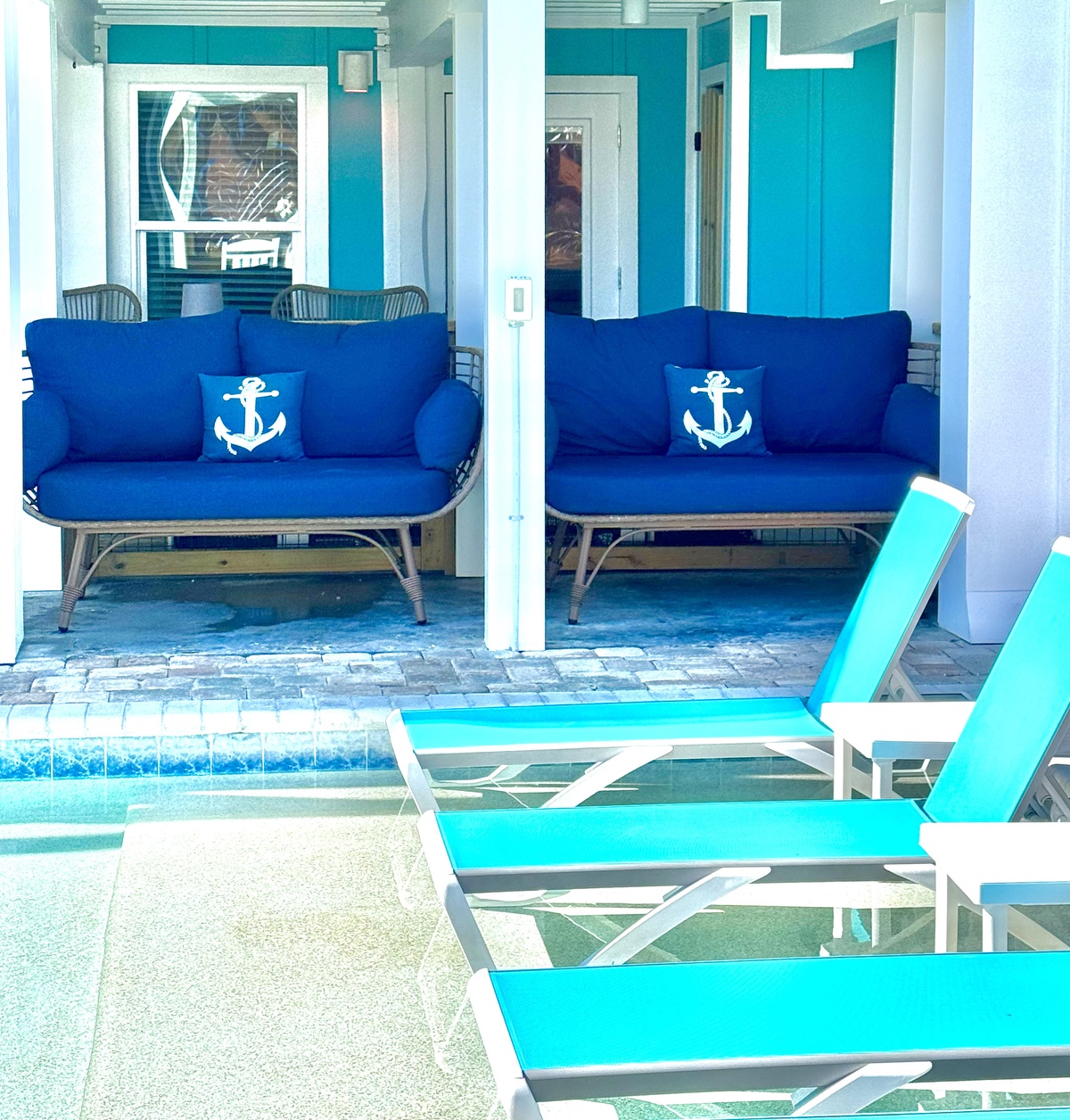 Sink into nautical comfort by your private pool, where anchor-themed cushions and turquoise loungers create your perfect seaside retreat.