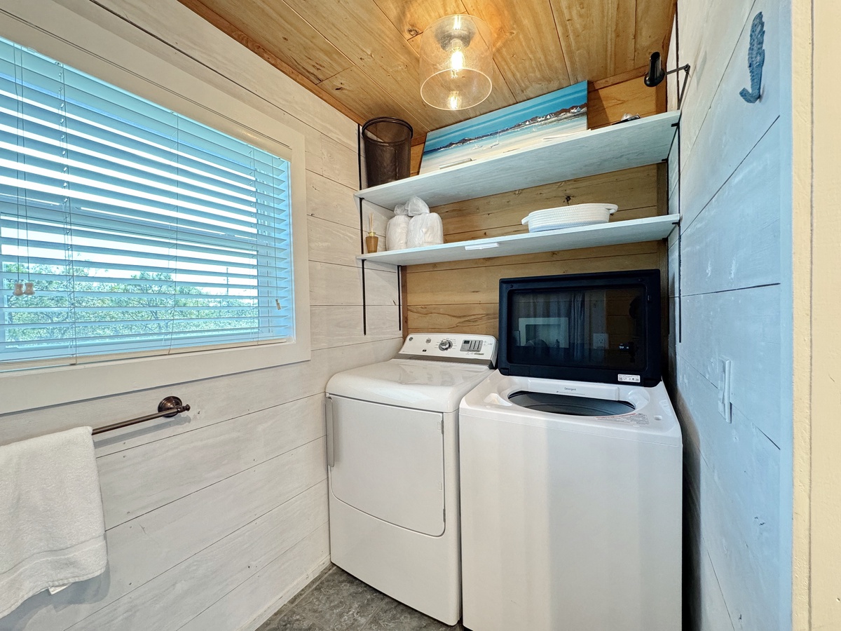 Your own laundry nook with full-size washer and dryer, plus smart storage for linens and essentials.