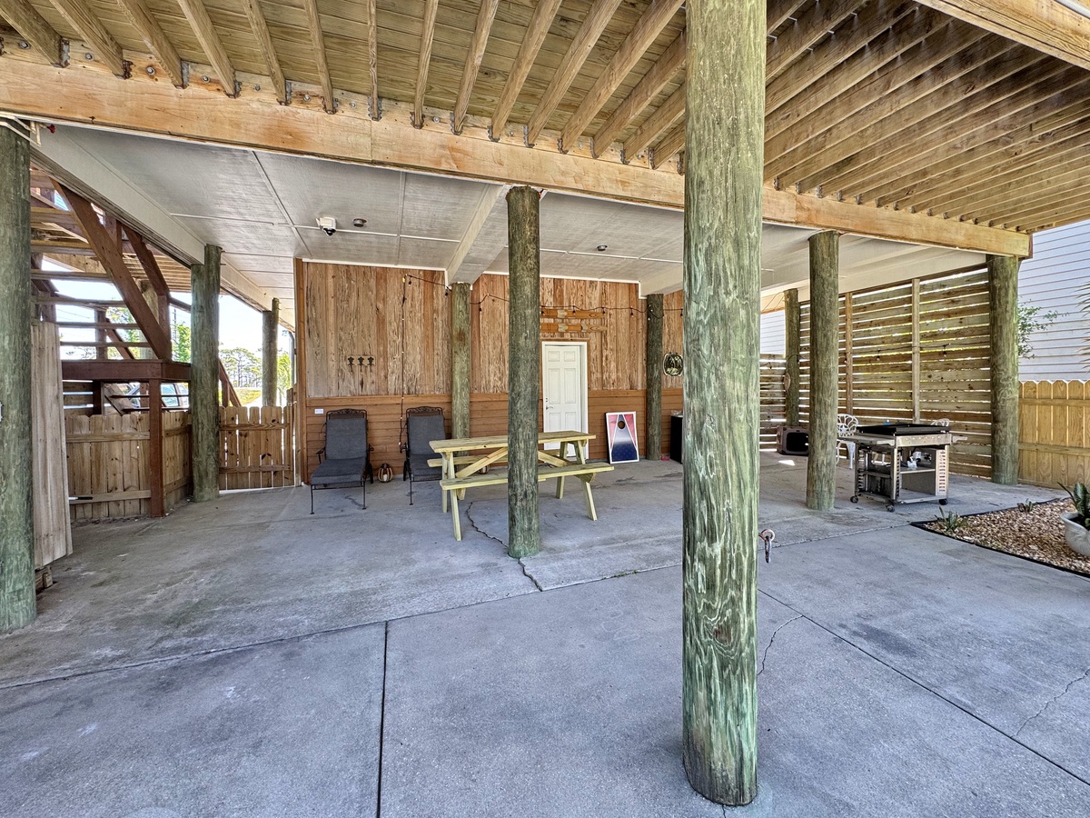 Your private covered patio awaits with rustic wood beams, comfortable seating, and BBQ facilities for memorable outdoor dining experiences.