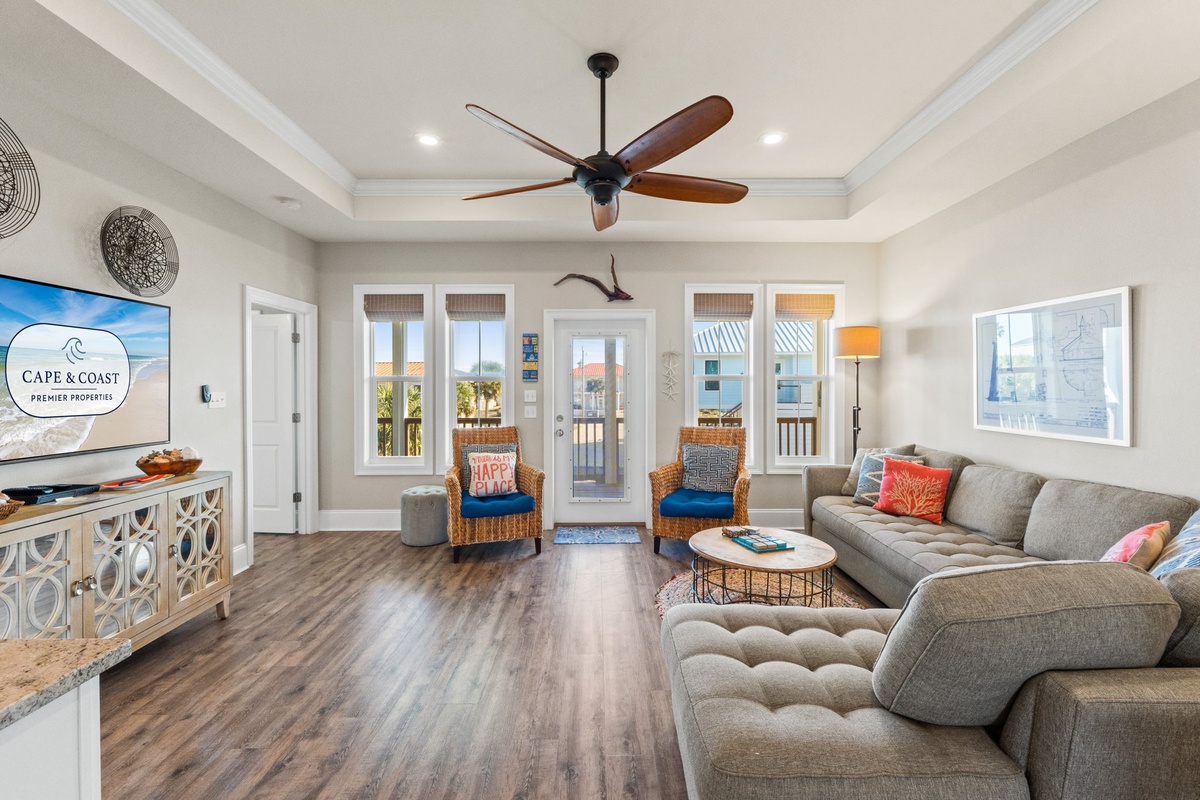 Unwind in your spacious living room with soaring coffered ceilings and coastal views from French doors opening to your private balcony.