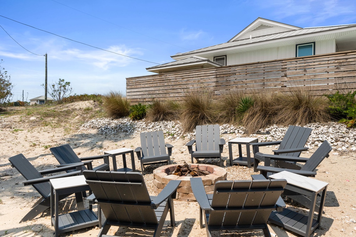 This charming beach house sits right on the sand with a private fire pit surrounded by cozy seating—perfect for gathering under the stars or soaking up the coastal breeze.
