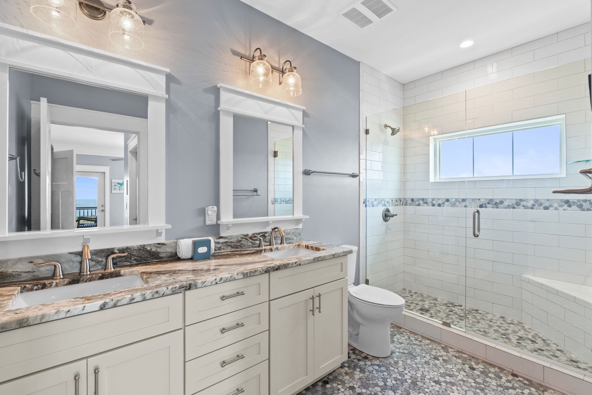 Step into your luxurious ensuite with dual vanities, granite countertops, and a spacious glass shower—your private spa retreat awaits.