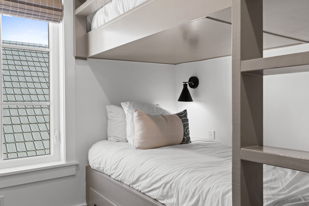 Drift off in your cozy built-in bunk with crisp linens, personal reading light, and charming rooftop views.