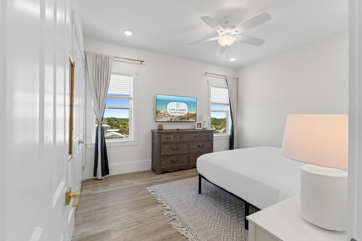Drift into peaceful sleep in your bright, airy bedroom with ocean views and gentle ceiling fan keeping you cool.