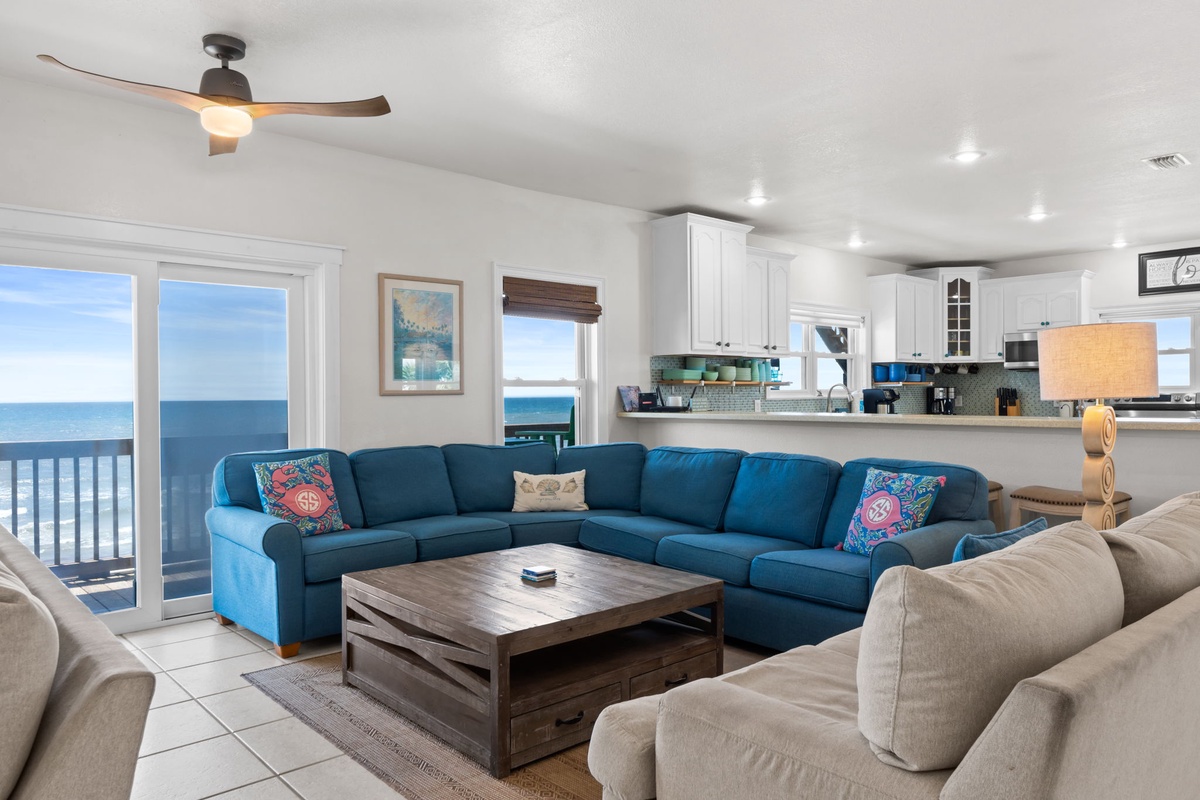 Sink into plush sofas with your morning coffee and watch the waves roll in through floor-to-ceiling windows. Your oceanfront retreat features a bright, open kitchen and spacious layout perfect for gathering with loved ones.