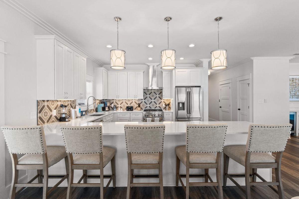 Step into your dream kitchen where style meets function. Gather around the generous island with seating for five, prepare meals on sleek countertops, and enjoy the warm ambiance of elegant pendant lighting overhead.