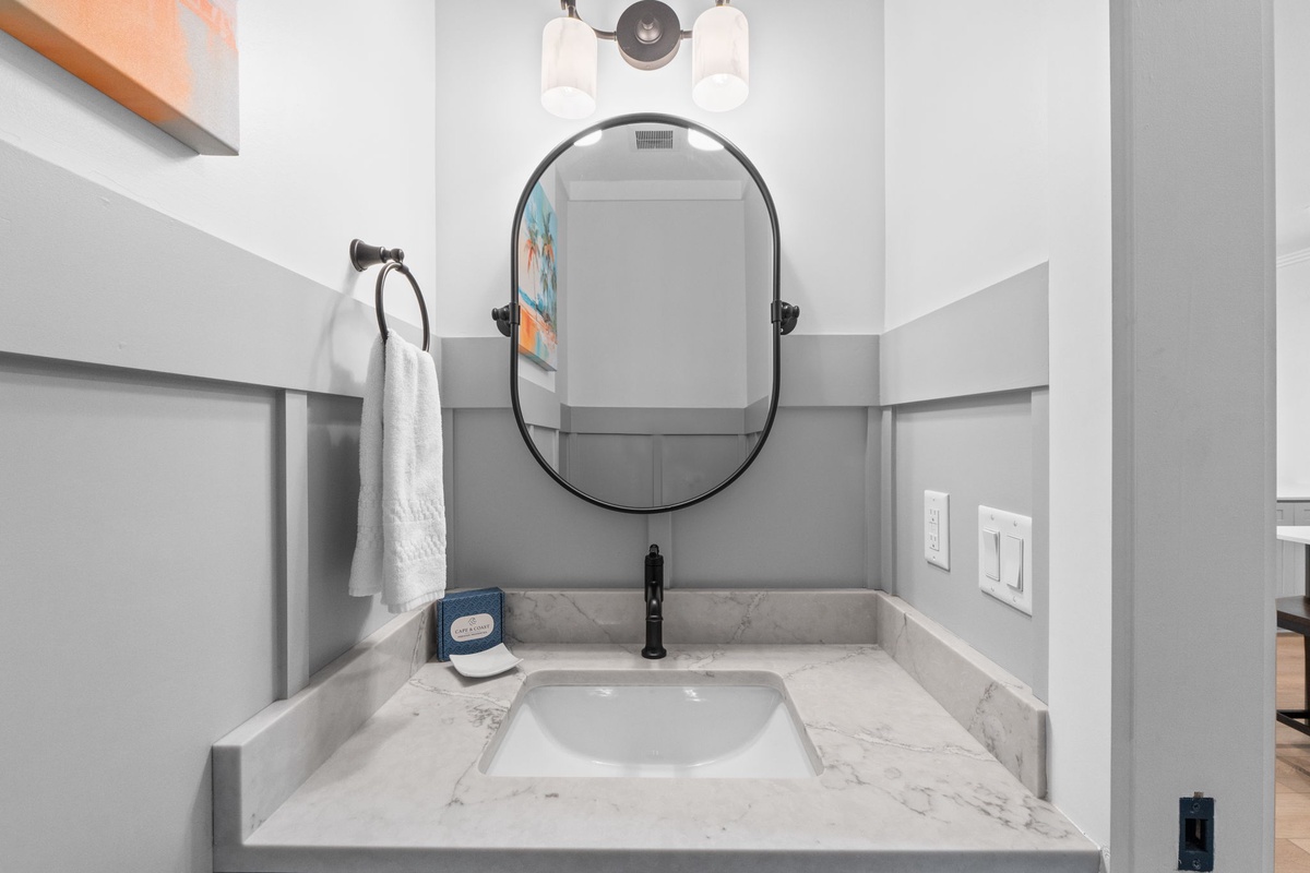 Freshen up at your private vanity with marble countertop, sleek oval mirror, and thoughtful touches like fresh towels waiting for you.