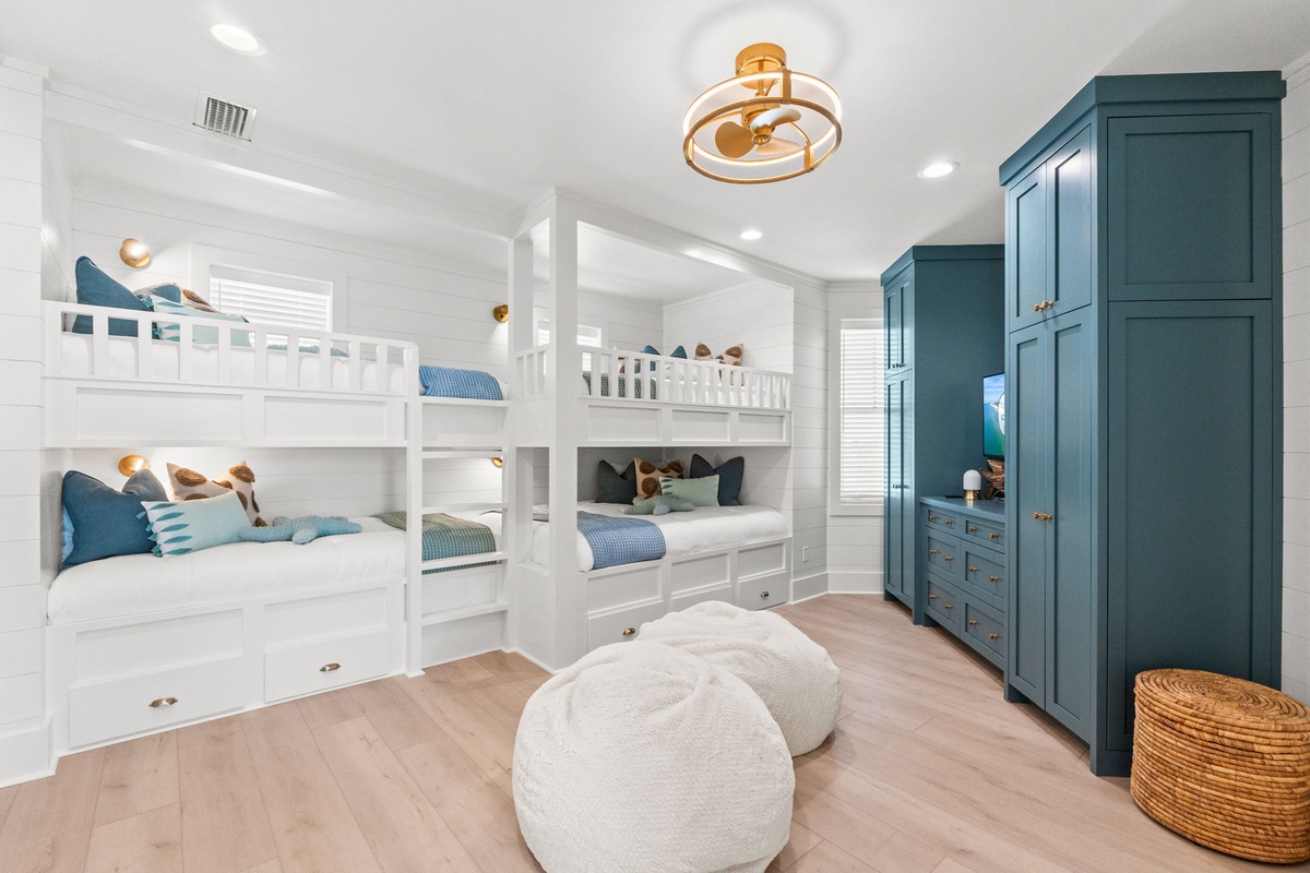 Your kids will love this fun bunk room with cozy built-in beds, ample storage, and playful coastal touches perfect for family adventures.