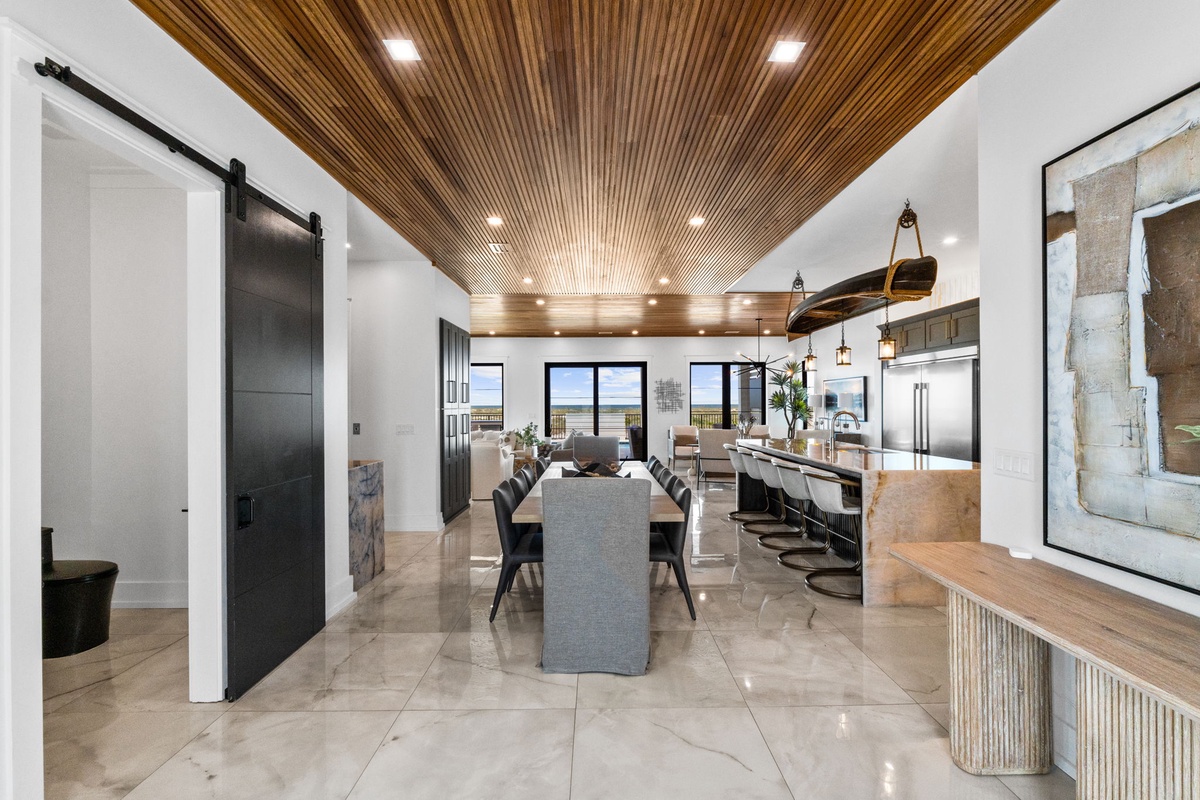 Gather around this stunning dining space where sleek design meets comfort, complete with a gourmet kitchen and sweeping water views to enjoy during your meals together.