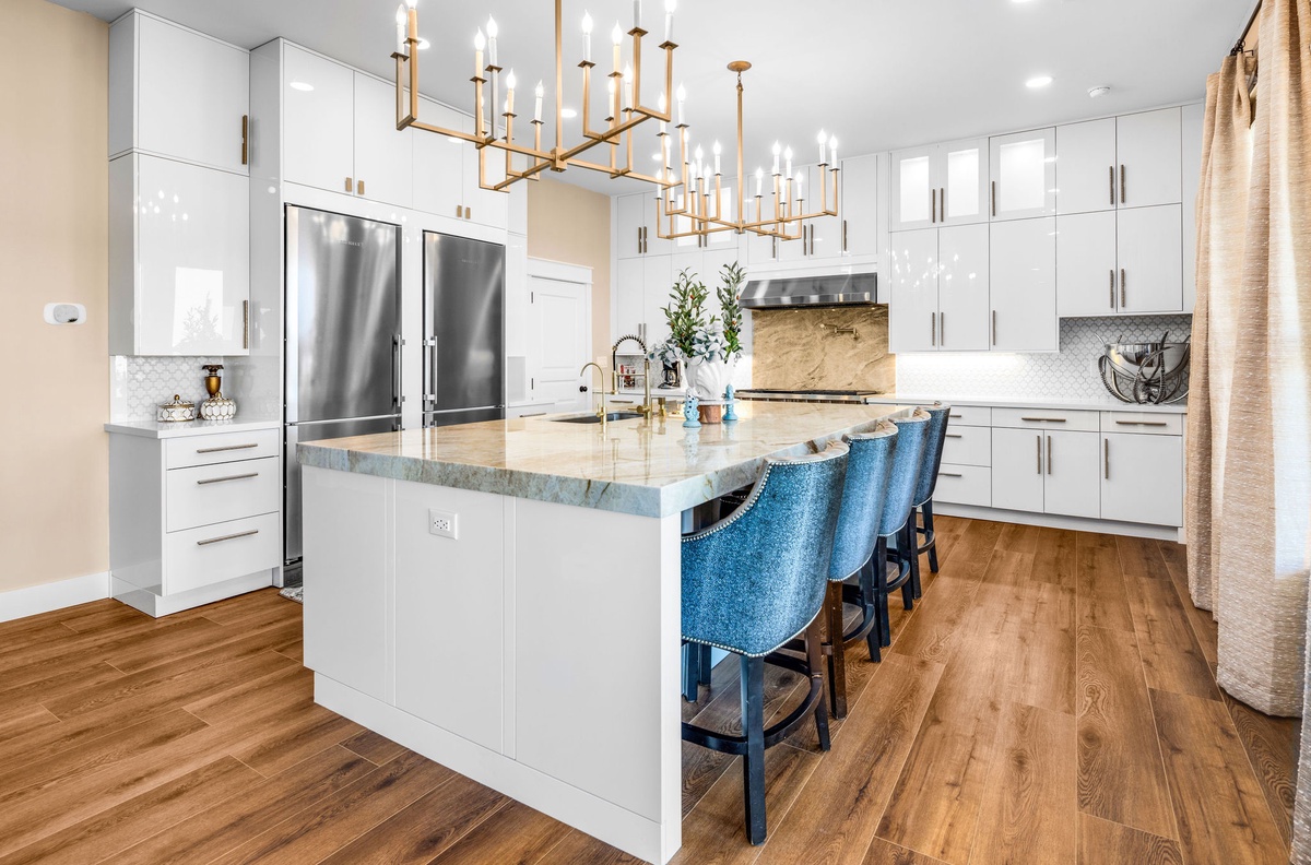 Your gourmet kitchen awaits with premium appliances, elegant marble island, and stylish seating for memorable meals together.