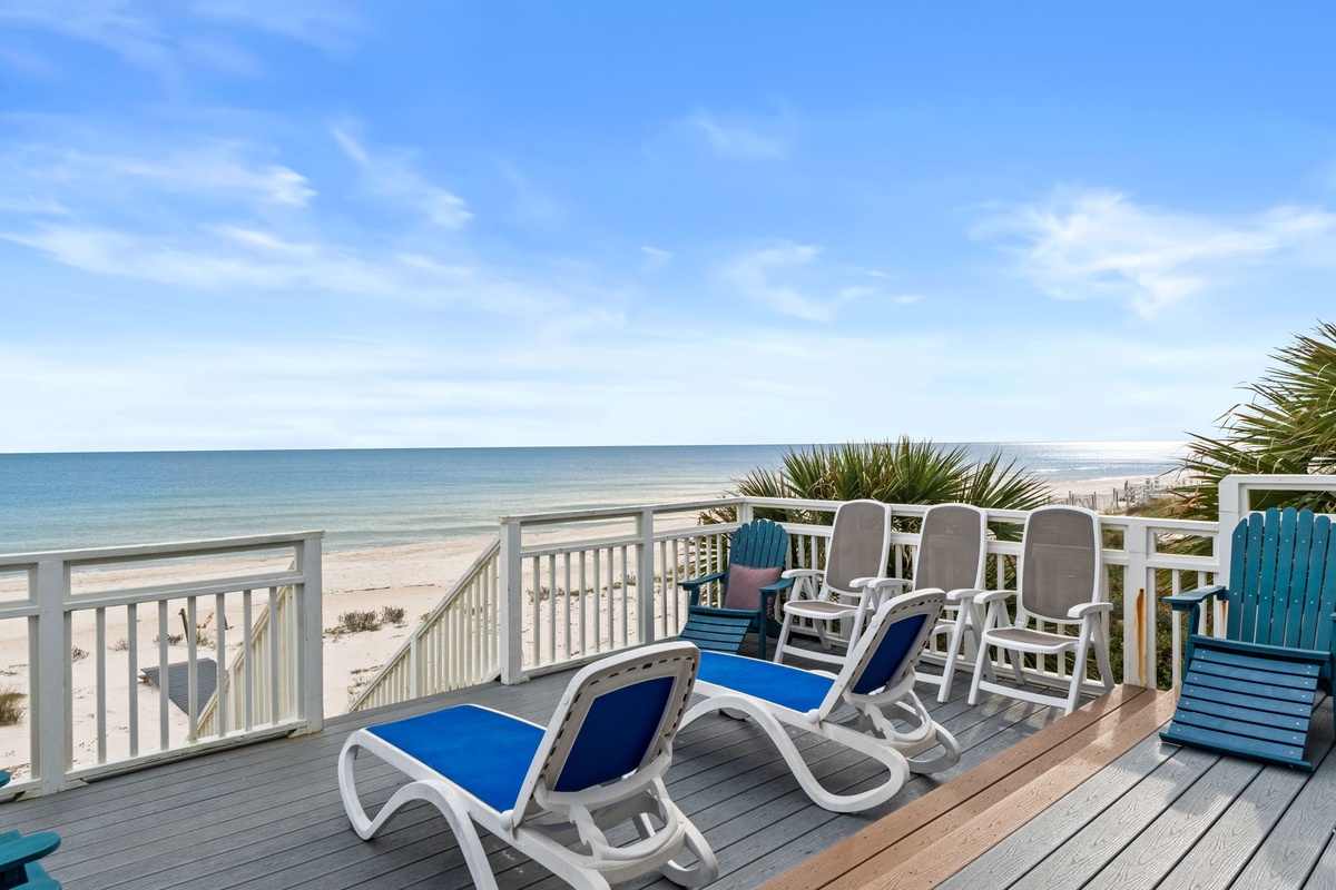 Unwind on your private beachfront deck with lounge chairs perfectly positioned for stunning ocean views and tropical breezes.