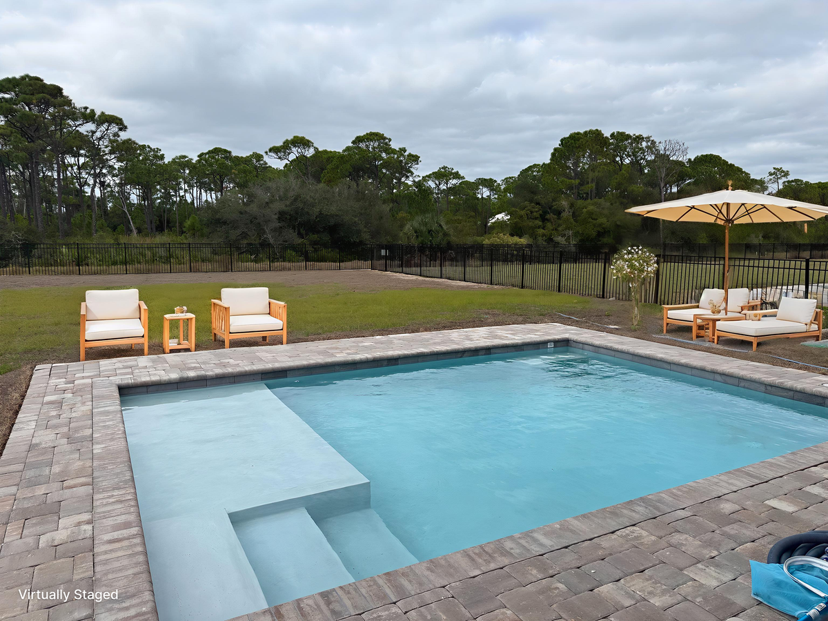 Your private pool oasis awaits with comfortable lounge chairs and umbrella shade for the perfect day of relaxation.
