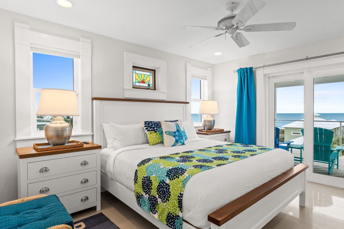 Wake up to ocean views from your coastal bedroom with vibrant decor and private balcony access for peaceful mornings.
