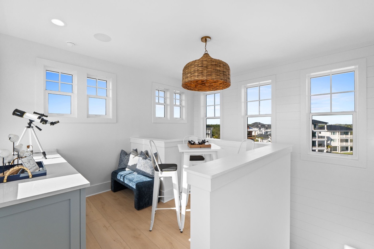Unwind in your bright loft workspace, where natural light fills the room and a cozy reading nook awaits your quiet moments.