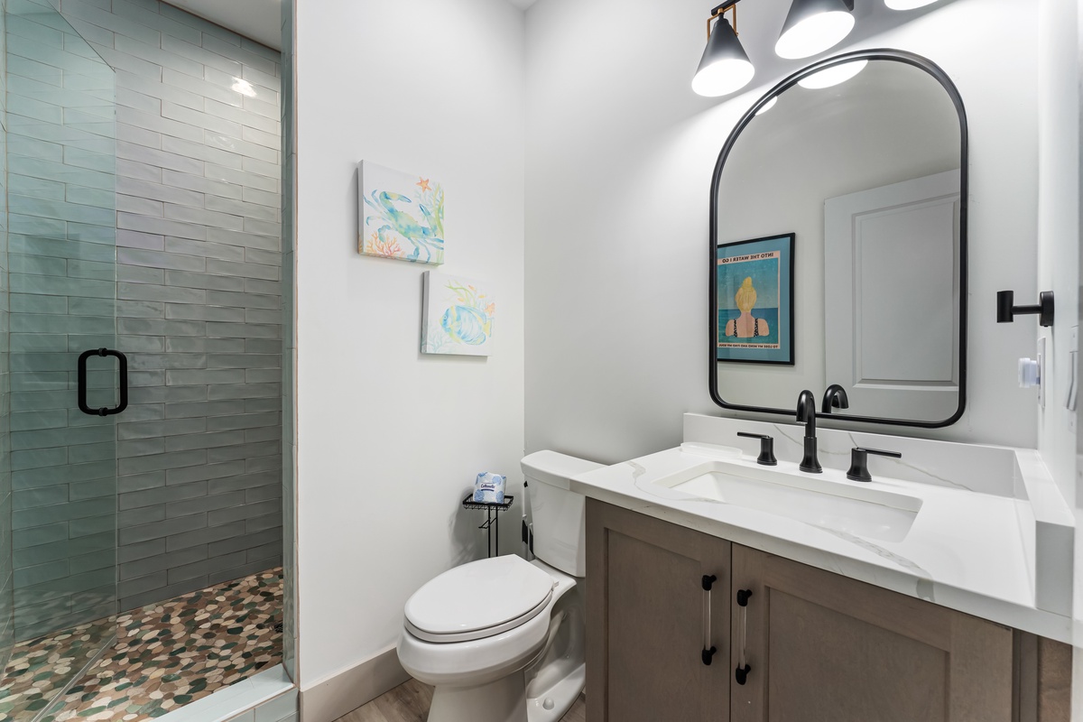 Refresh in your beautifully appointed bathroom with spa-like tile shower, stylish vanity, and thoughtful coastal touches that make every morning feel special.