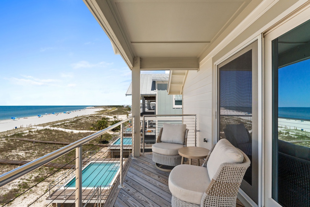 Beachfront property offering coastal views, outdoor pool, and modern architecture surrounded by natural sand dunes and pristine shoreline—visible upon arrival.