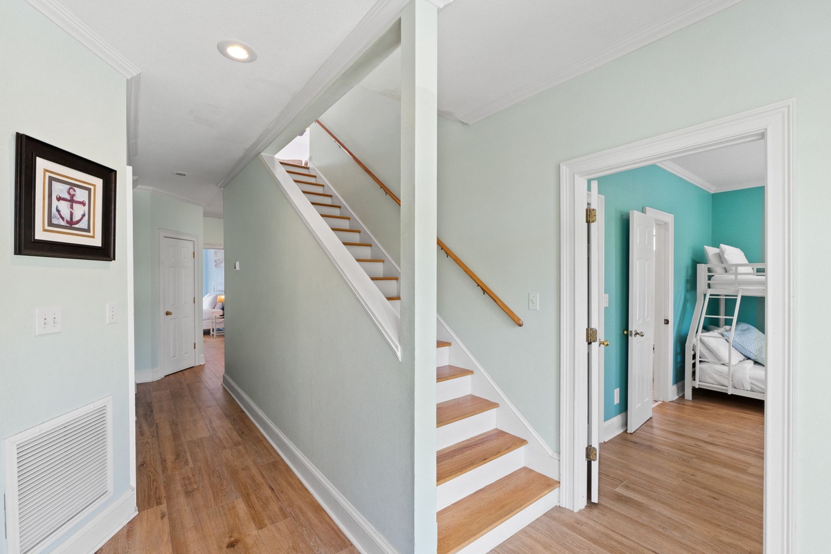 Your coastal retreat awaits with charming hardwood floors and nautical touches throughout these bright, welcoming hallways.